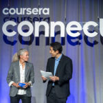 Andrew Ng congratulates a Coursera Partner Award winner